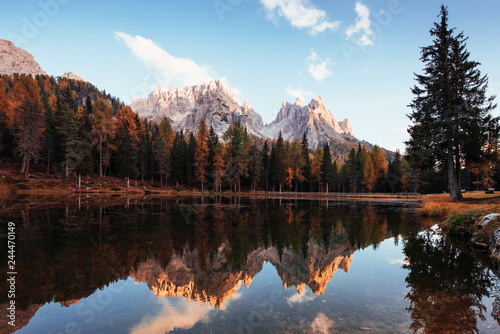Deep autumn. Gorgeous mountains in clouds. Great landscape. Woods near the lake