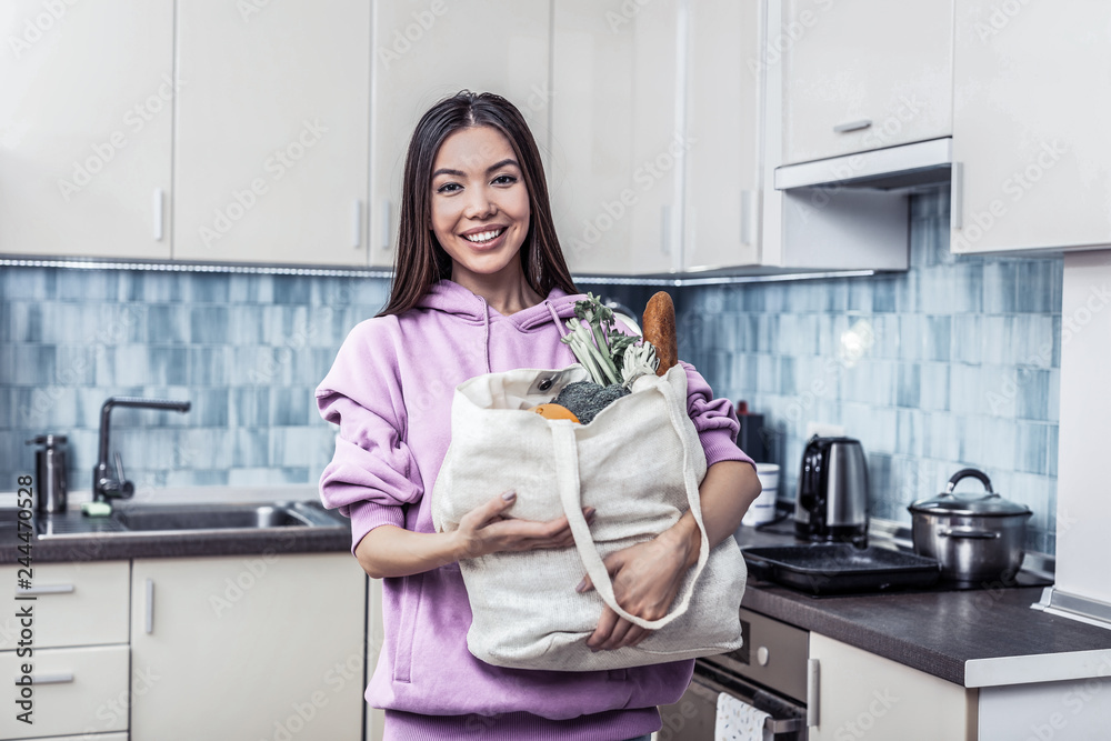 Smiling housewife feeling excited before cooking dinner Smiling housewife feeling excited before cooking dinner