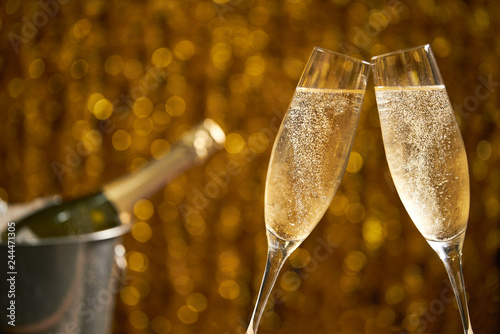 Glasses of champagne on a golden background, party or holiday concept photo