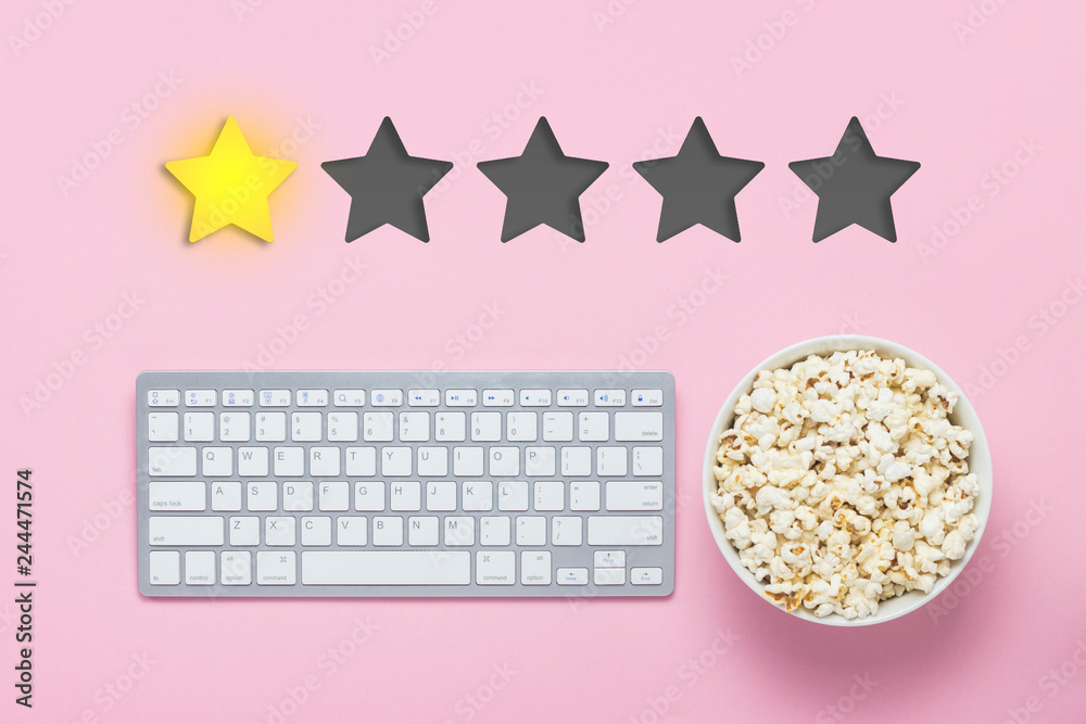 Bowl of popcorn, keyboard on a pink background. Added one star rating