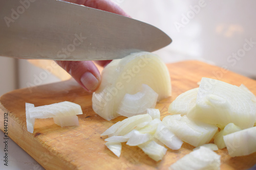 cutting onion on a wooden board