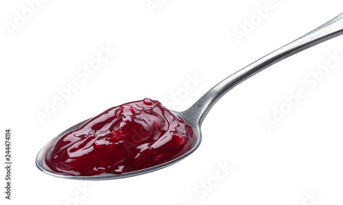 Spoon of red jam isolated on white background photo