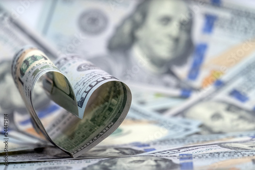 Hundred dollar banknote of usa in the shape of a heart. Money background. Concept financial love and a gift for Valentine's Day. Copy space.