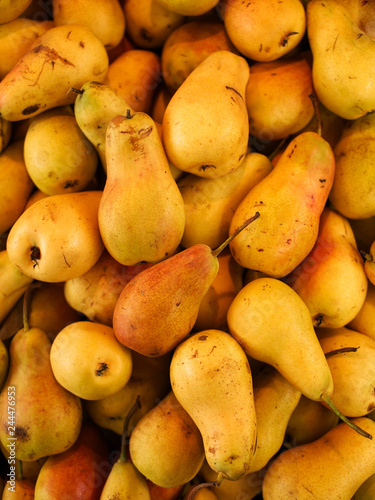 Background of ripe yellow pears closeup