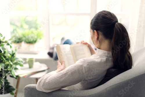 Woman relaxing and reaing a book