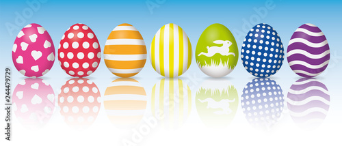 Holiday banner, colorful easter eggs with white patterns, reflection on white surface, sky background