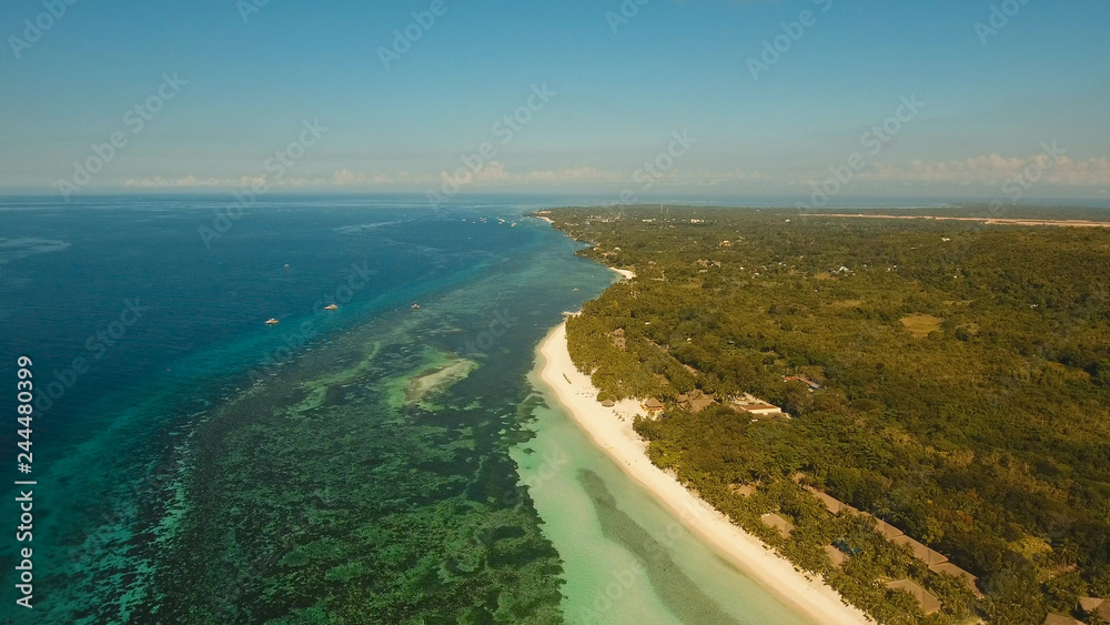 Aerial view tropica Alona beach on the island Bohol, resort, hotels, Philippines. Beautiful tropical island with sand beach, palm trees. Tropical landscape. Seascape: Ocean, sky, sea. Travel concept