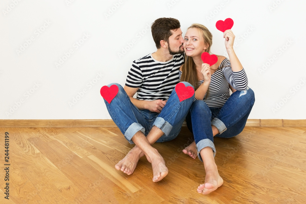 Young man is kissing girl on her cheek. Valentines day. Young man is kissing girl on her cheek. Valentines day.
