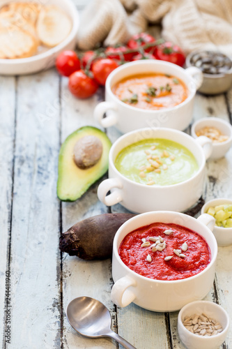 Variety of different colorful vegetable cream soups in a bowls. Concept of healthy eating or vegetarian food.