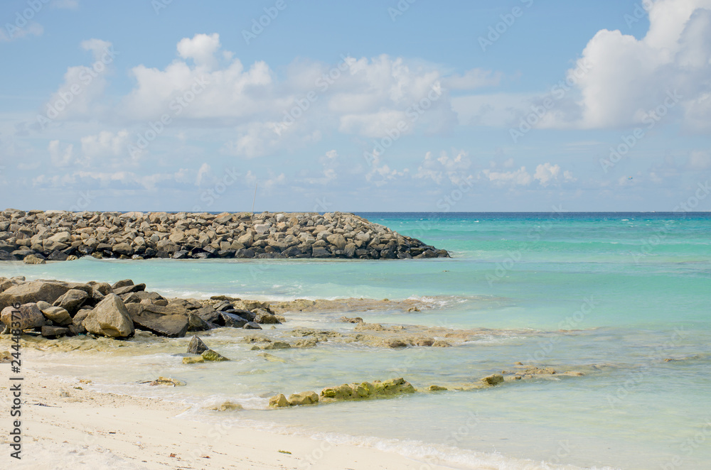 Landscape Maldive island blue ocean white sand and stones ashore
