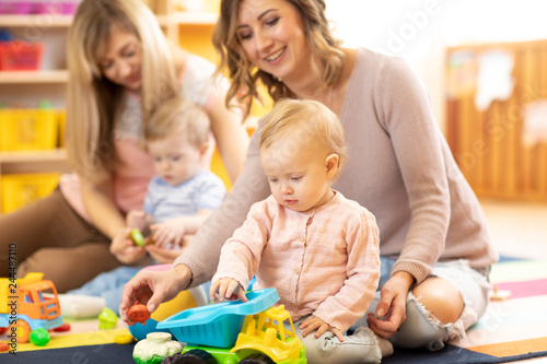 Moms with babies playing on the floor. Moms with daughter and son playing in car