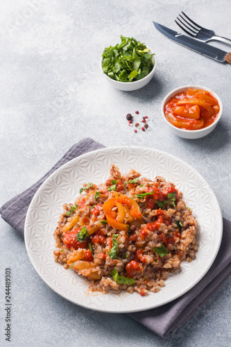 Buckwheat porridge with canned tomato and pepper. Copy space