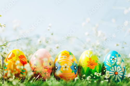 Decorative eggs on green grass.