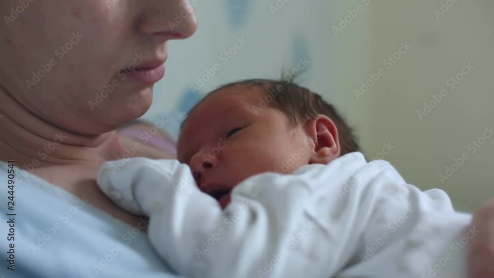 Newborn baby sleeping peacefully over the mother chest Newborn baby sleeping peacefully over the mother chest
