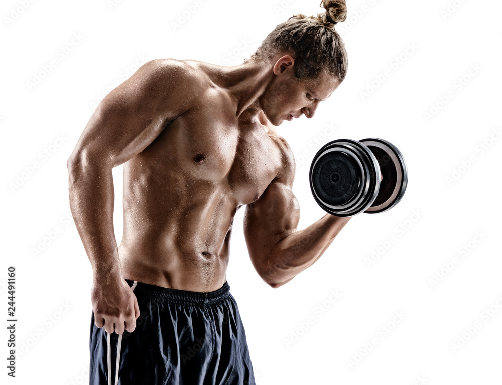 Muscular young guy doing exercises with dumbbell at biceps. Photo of sporty man with naked torso on white background. Strength and motivation
