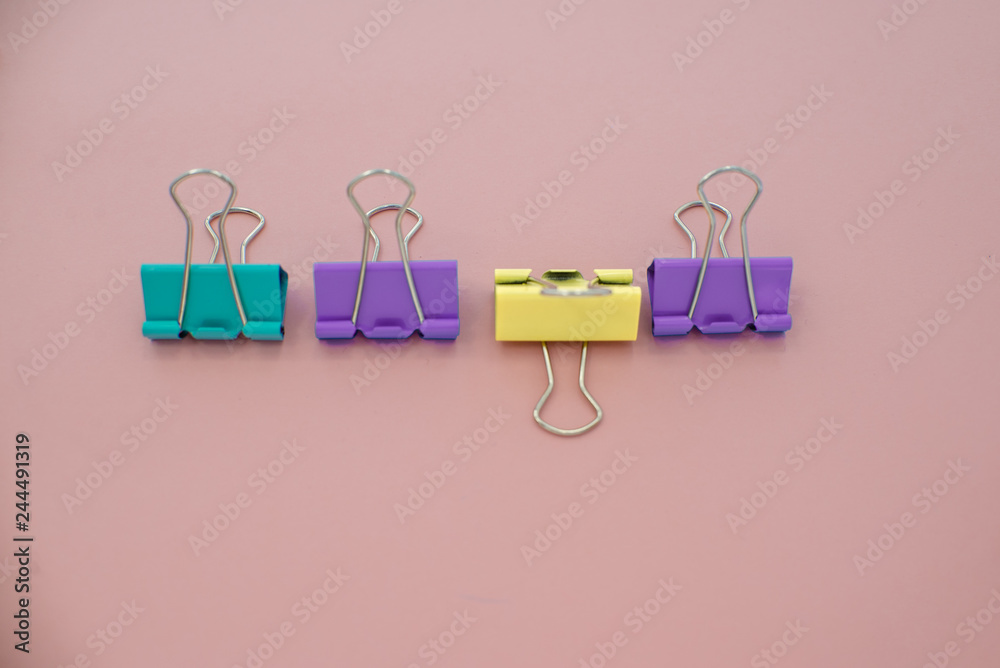 colored paper clips on a pink background. Office stationary colored paper clips on a pink background. Office stationary