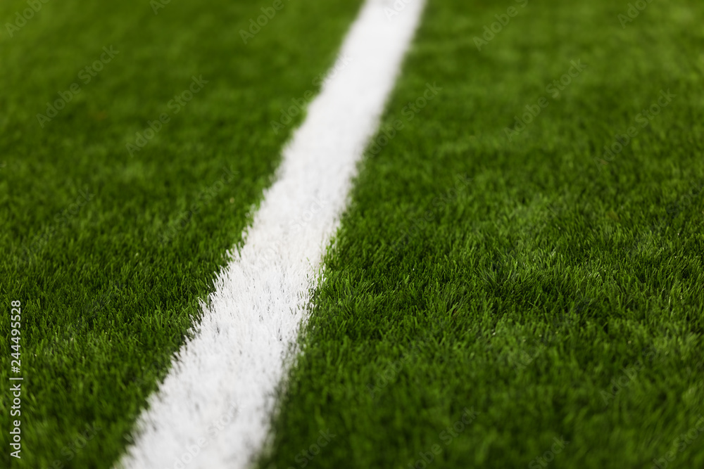 Close-up of artificial turf of soccer pitch. Soccer football field detail