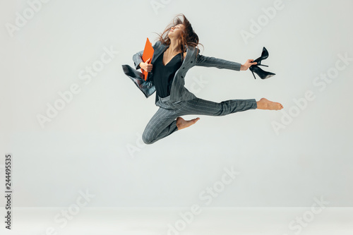 Happy business woman dancing and smiling in motion isolated over white studio background. Human emotions concept. The businesswoman, office, success, professional, , happiness, expression concepts