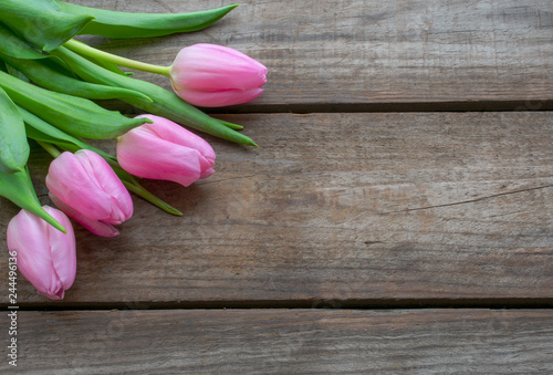 Fototapeta Naklejka Na Ścianę i Meble -  Pink Tulips on  a rustic wooden background