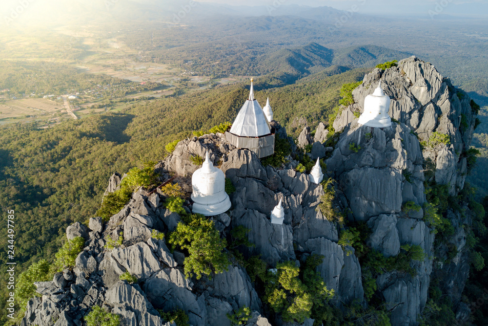 Fototapeta premium Spectacular aerial view of floating pagodas on the mountain cliff at Wat Chaloem Phra Kiat in Chae Hom District, Lampang province, Thailand.