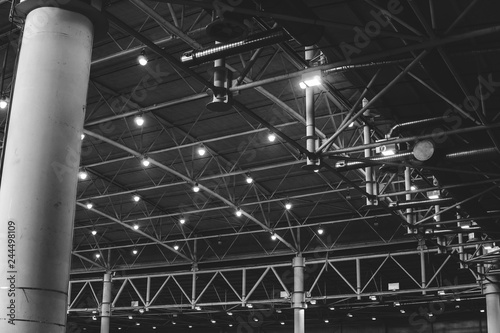 Interior of warehouse. large metal structures  ceiling. roof. concept production and installation of equipment for rooms  lighting  ventilation and windows for hangars  black and white
