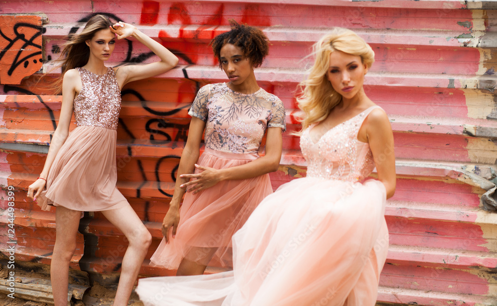 Street fashion three models in pink dress