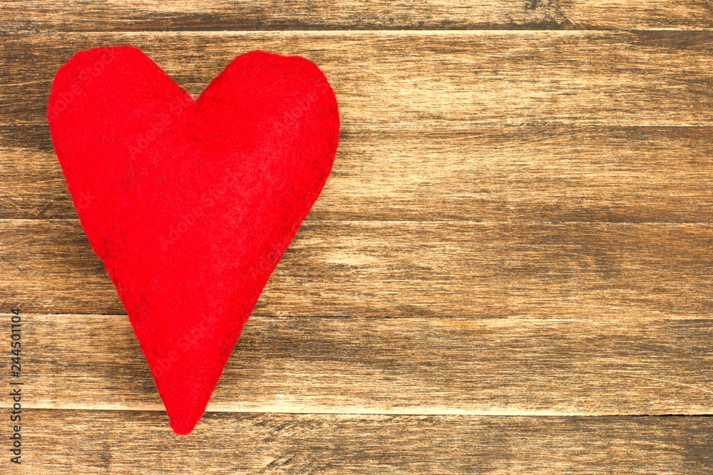 Red felt heart on wooden plank.Valentine's day background Red felt heart on wooden plank.Valentine's day background