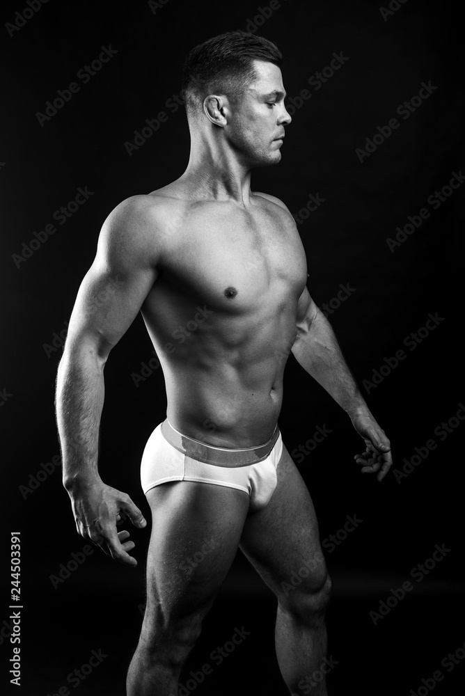 Fototapeta premium strong athletic man on black background