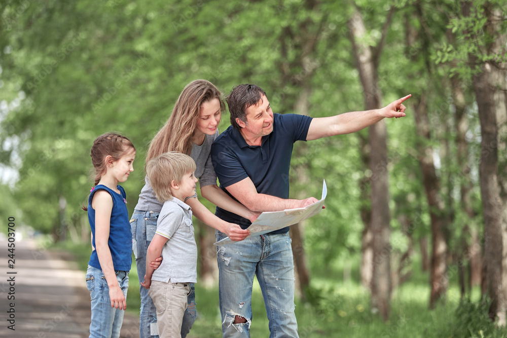 family with children discussing the route of travel on the map