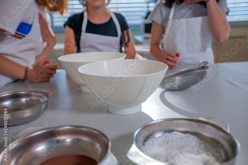 Fototapeta Naklejka Na Ścianę i Meble -  Kids are ready to start a cooking class. All the bowls are ready on the table.