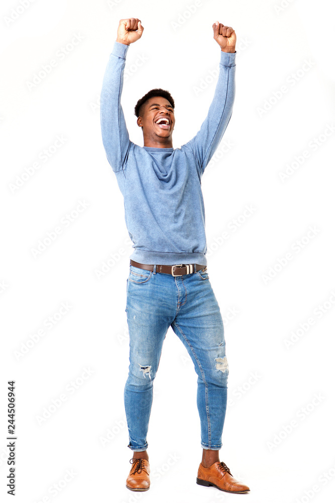 Full body cheerful young black man with arms raised against isolated white background Full body cheerful young black man with arms raised against isolated white background