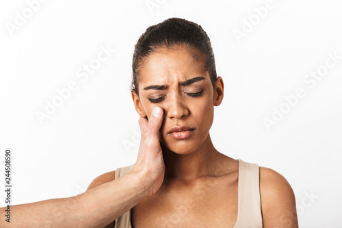 Upset young african woman crying with man's hand