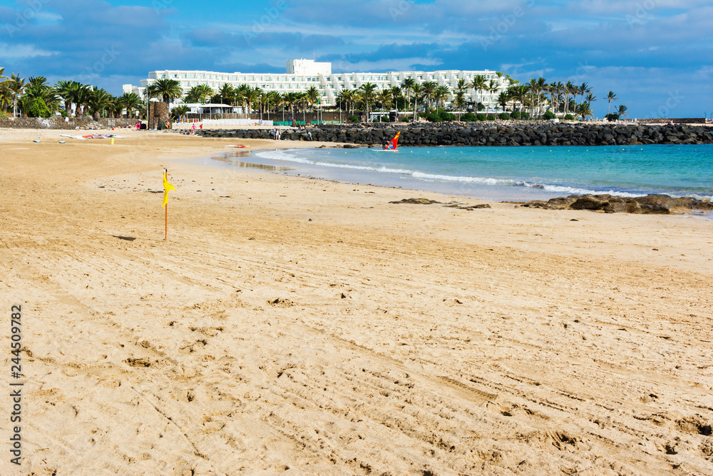 Obraz premium View of Playa de las Cucharas beach in Costa Teguise, Lanzarote, Spain, clear turquoise waters, selective focus