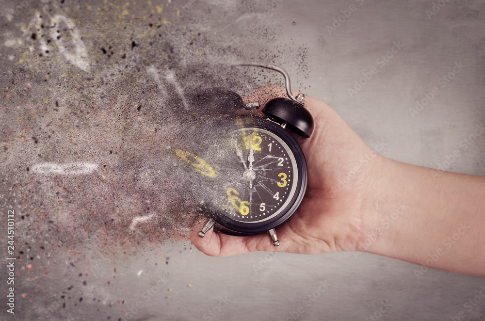 Time is running out concept. The clock breaks down into pieces. Hand