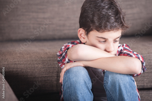 Sad kid lost in his thoughts