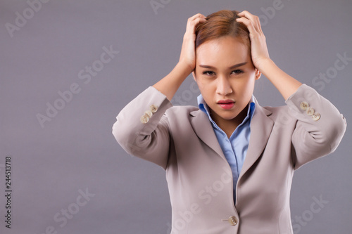 asian businesswoman suffering from headache; portrait of professional failed asian business woman boss with headache, stress, frustration, problem; Southeast asian young adult woman model