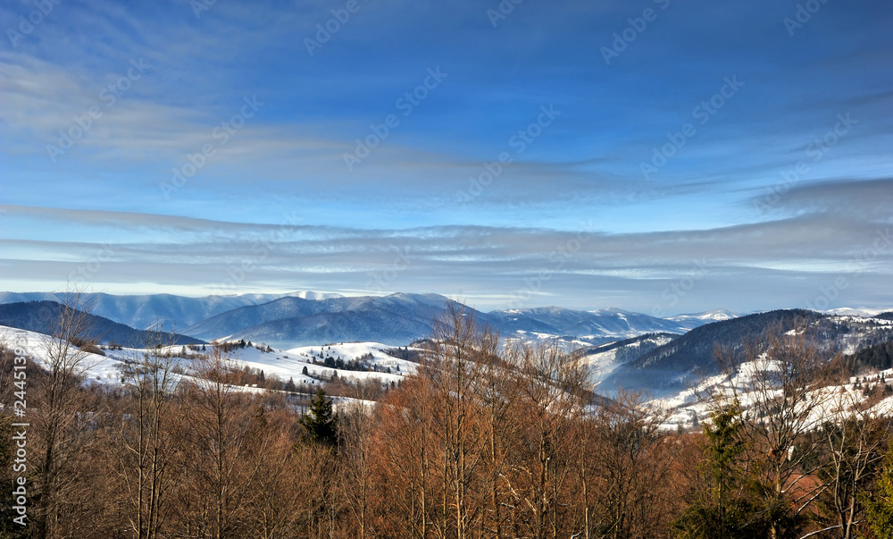 Nice mountains view in snowy sunny day under blue sky with sun light at winter time