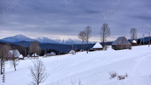 Panoramic view of idyllic winter mountain tops and traditional mountain huts in the Carpathians © nmelnychuk