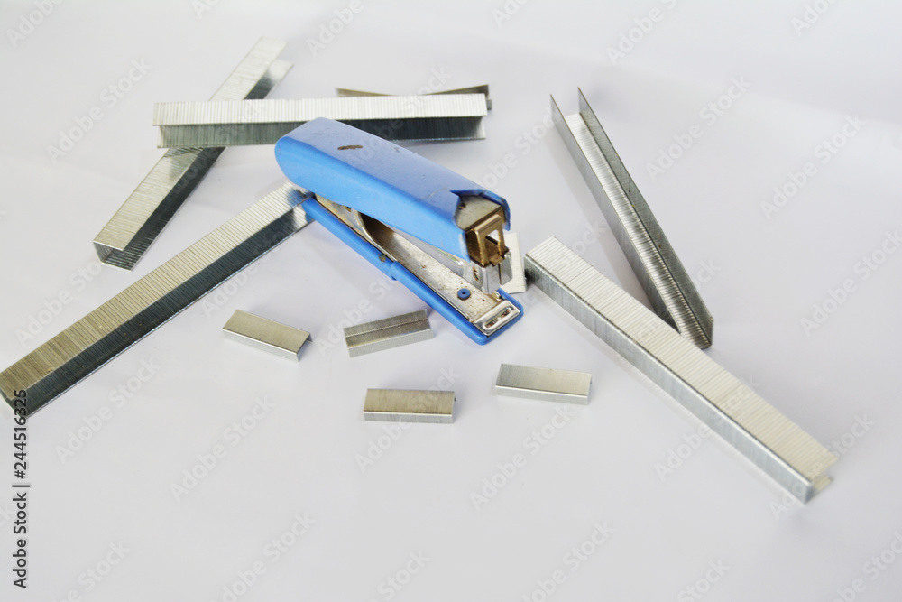 Blue stapler and staples on a white background