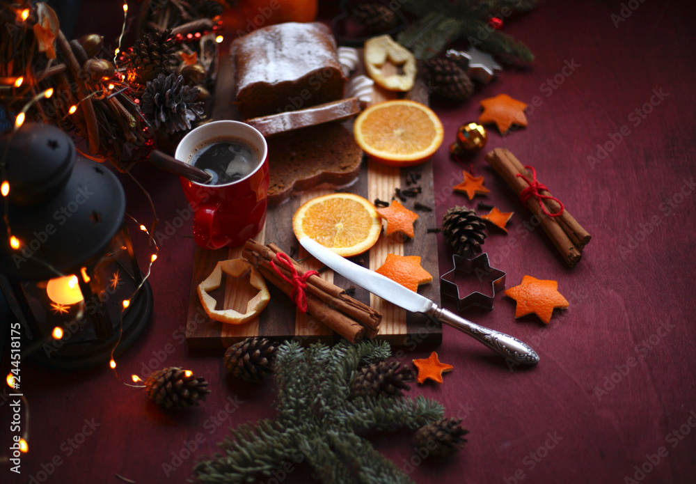 Christmas and New year background with Pie and a mug of coffee on the cutting board,oranges,Tree decorations ,lantern,  lights/top view/flat lay