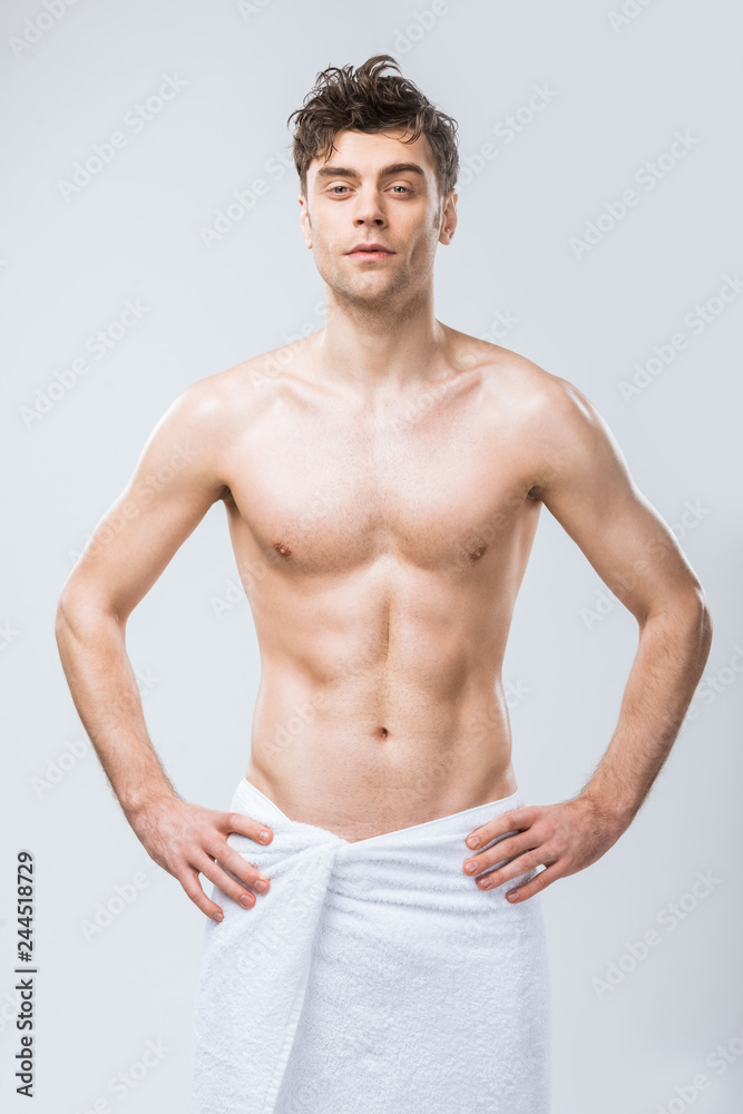 sexy shirtless macho posing in towel isolated on grey sexy shirtless macho posing in towel isolated on grey