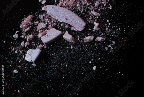 Crushed duochrome blush or eye shadow on black background.