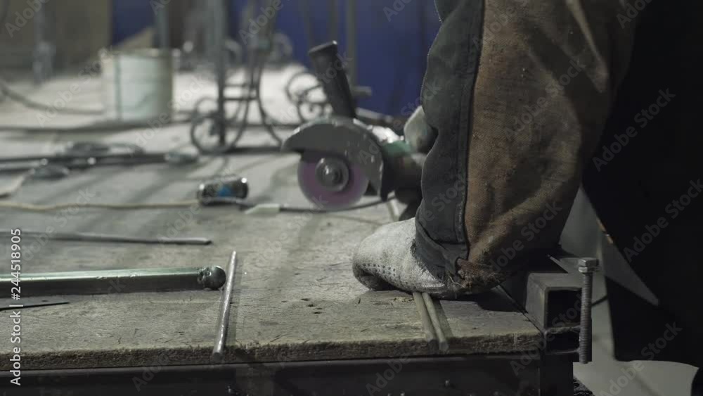 Close-up - A Blacksmith In Protective Gloves Lays Two Iron Rods Close-up - A Blacksmith In Protective Gloves Lays Two Iron Rods