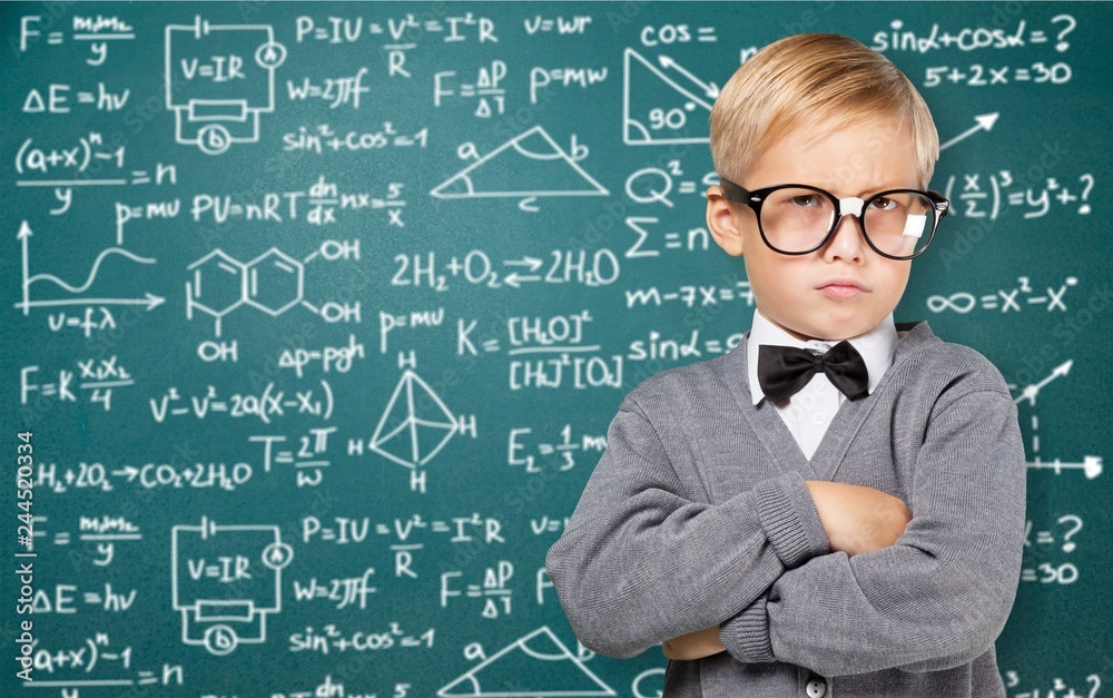 Cute little schoolgirl in glasses on blackboard background Cute little schoolgirl in glasses on blackboard background