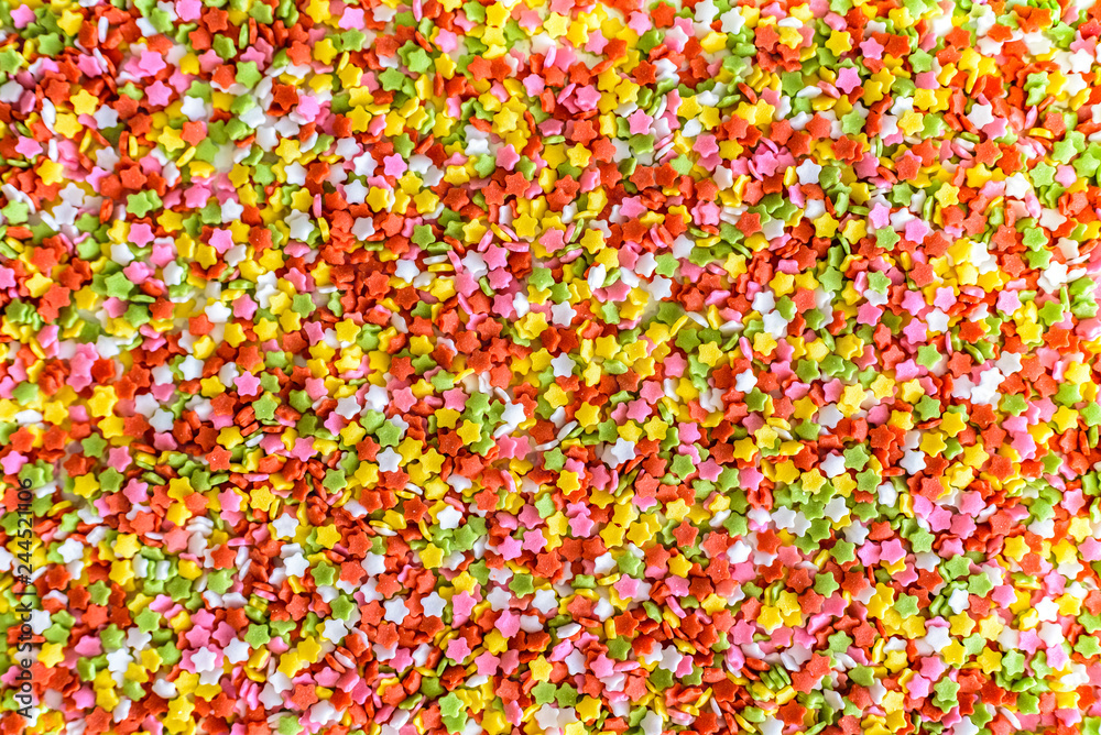 Close-up of colorful little stars made of sugar to decorate desserts, culinary background. Close-up of colorful little stars made of sugar to decorate desserts, culinary background.