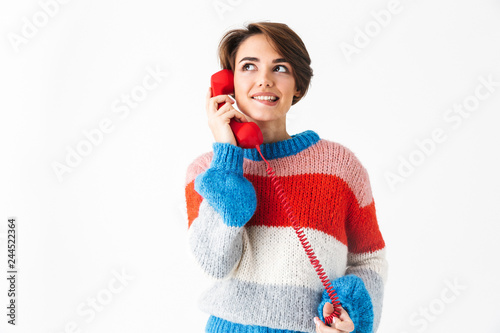 Happy cheerful girl wearing sweater standing