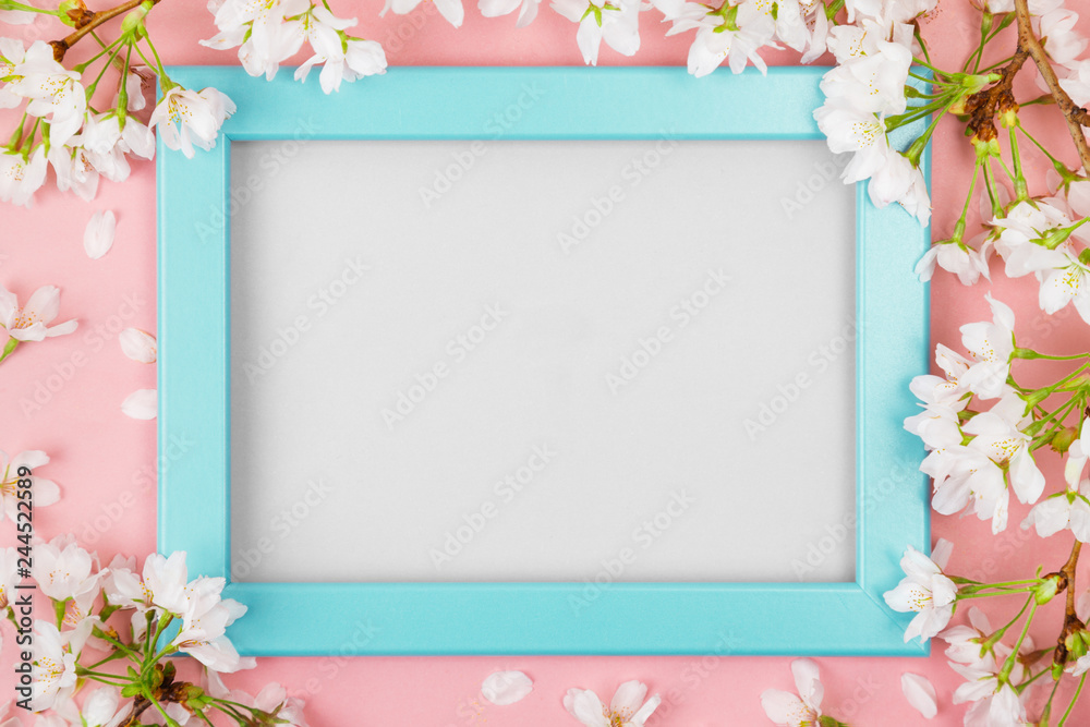 Turquoise springtime frame with blank space and cherry blossom Turquoise springtime frame with blank space and cherry blossom