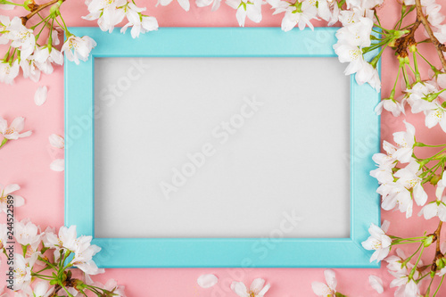 Turquoise springtime frame with blank space and cherry blossom © asife