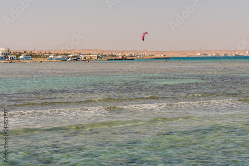 Kitesurfing Kiteboarding action photos man among waves quickly goes. A kite surfer rides the waves. vertical photo.