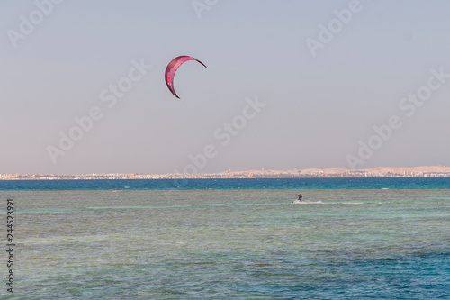 Kitesurfing Kiteboarding action photos man among waves quickly goes. A kite surfer rides the waves. vertical photo.